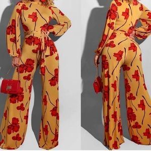 Mustard jumpsuit with red-orange flower detailing and zip-up back Size Medium